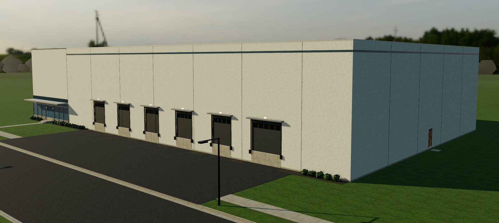 A tilt-up concrete warehouse with dock-high doors and a glass office corner